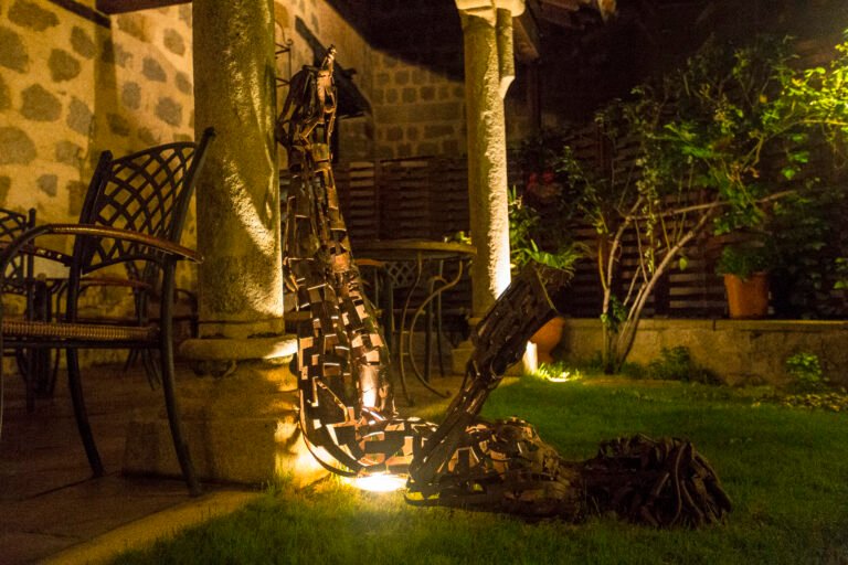 A beautiful statue of a man reading lying face down at night, Avila